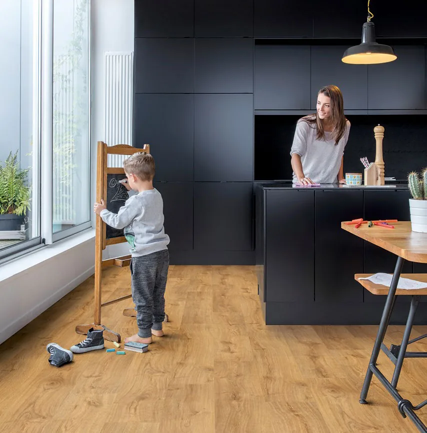 A wood-look vinyl floor running through a family kitchen